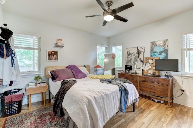 809 E 44th St, Austin, TX 78751 - bedroom with multiple windows, light wood finished floors, and a ceiling fan