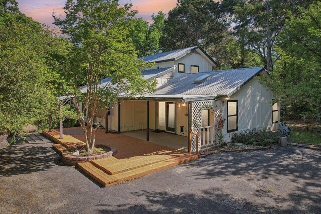 115 Pine Cone Ln, Elgin, TX 78621 - back of property featuring metal roof and a wooden deck