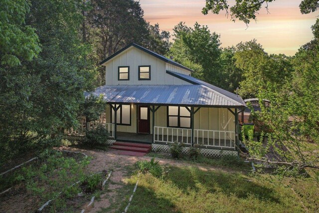 115 Pine Cone Ln, Elgin, TX 78621 - view of front facade featuring covered porch, board and batten siding, and metal roof
