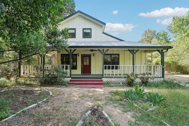 115 Pine Cone Ln, Elgin, TX 78621 - view of front facade featuring ceiling fan, board and batten siding, a porch, and metal roof