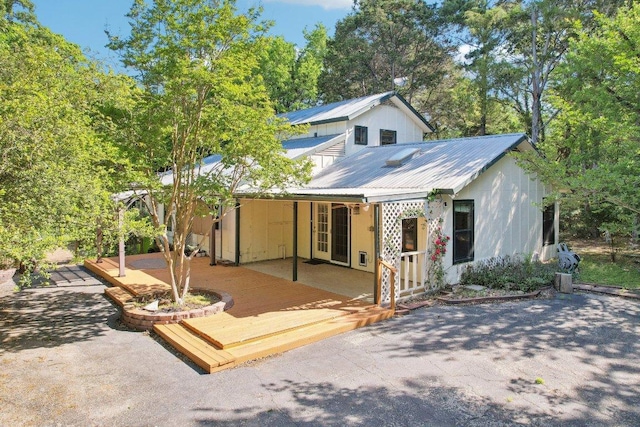 115 Pine Cone Ln, Elgin, TX 78621 - back of house featuring metal roof and a deck