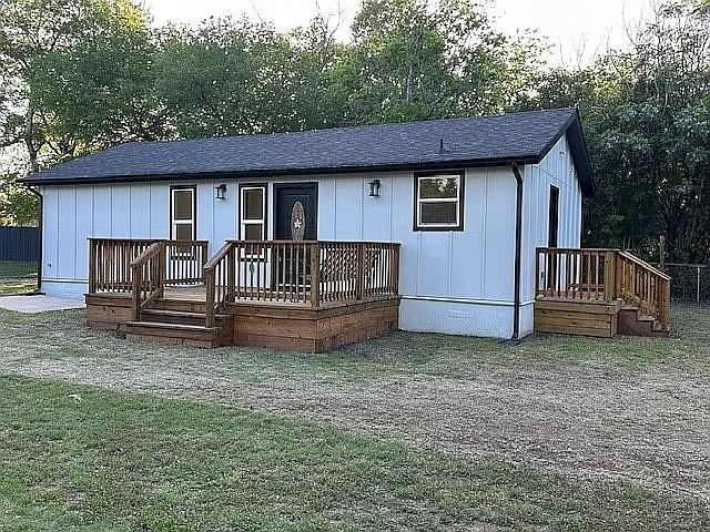 view of front of house with board and batten siding, crawl space, and a shingled roof