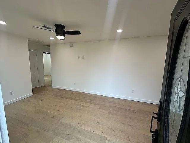 unfurnished room featuring recessed lighting, wood finished floors, baseboards, and ceiling fan
