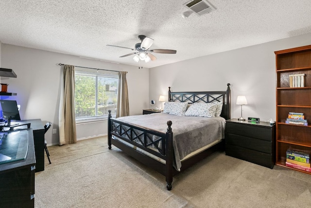 bedroom featuring ceiling fan, light carpet, a textured ceiling, and visible vents