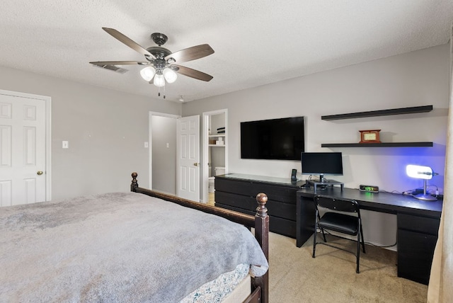 bedroom with visible vents, a ceiling fan, a textured ceiling, and light colored carpet