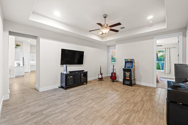 224 Highland Oaks, Leander, TX 78641 - living area featuring a tray ceiling, a ceiling fan, light wood-style floors, and recessed lighting