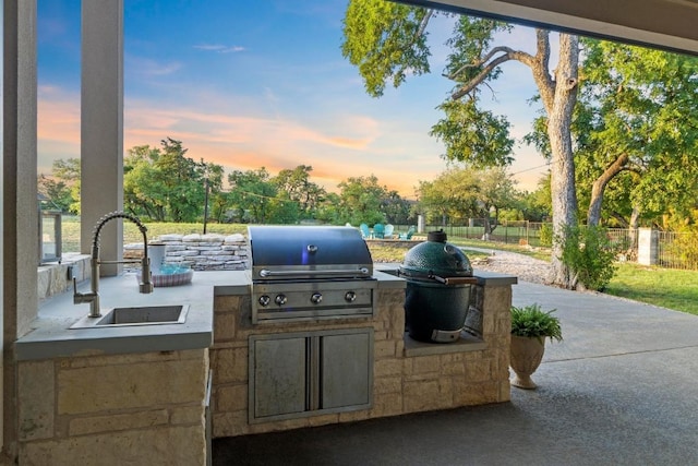 224 Highland Oaks, Leander, TX 78641 - patio terrace at dusk featuring an outdoor kitchen and a patio area