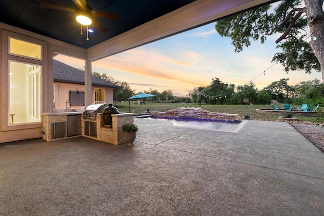 224 Highland Oaks, Leander, TX 78641 - patio terrace at dusk featuring area for grilling, a patio, ceiling fan, and a lawn