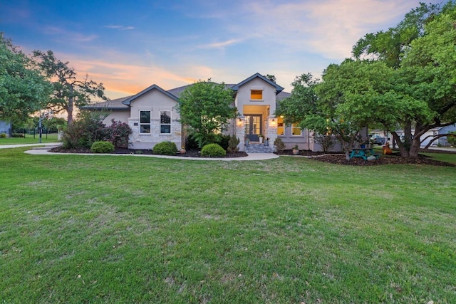 224 Highland Oaks, Leander, TX 78641 - view of front of home with a lawn, stone siding, and stucco siding