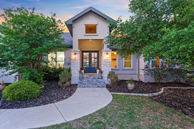 224 Highland Oaks, Leander, TX 78641 - view of front of property with french doors, stone siding, and stucco siding