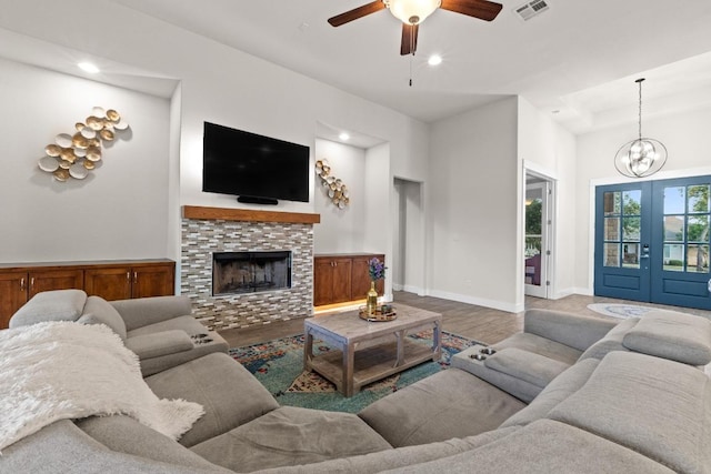 224 Highland Oaks, Leander, TX 78641 - living room with wood finished floors, a ceiling fan, a chandelier, recessed lighting, and a fireplace