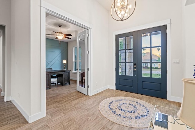 224 Highland Oaks, Leander, TX 78641 - foyer with french doors, wood finished floors, ceiling fan, and a chandelier