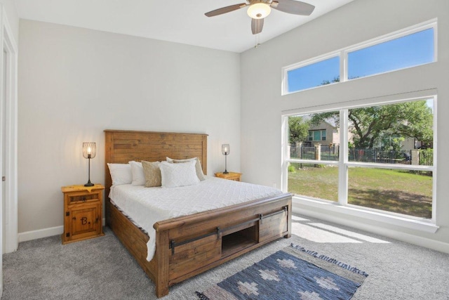 bedroom with carpet, a ceiling fan, and baseboards