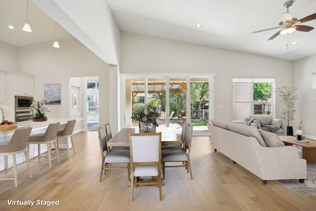 dining room with recessed lighting, a ceiling fan, high vaulted ceiling, and light wood-style floors