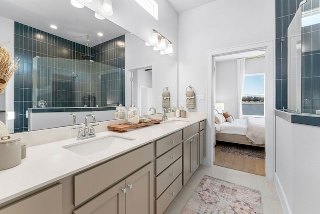 17508 Emperador Dr Unit 65, Pflugerville, TX 78664 - ensuite bathroom with double vanity, a tile shower, and tile patterned floors
