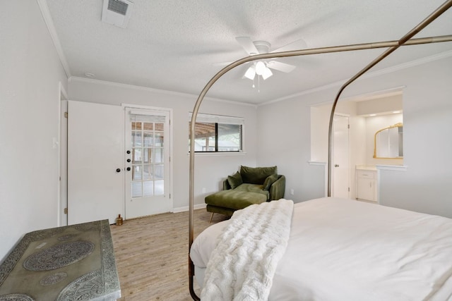402 San Gabriel Blvd, Georgetown, TX 78628 - bedroom featuring ornamental molding, light wood-type flooring, a ceiling fan, baseboards, and a textured ceiling