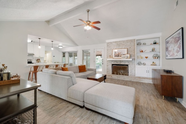 402 San Gabriel Blvd, Georgetown, TX 78628 - living room with ceiling fan, light wood finished floors, and a fireplace