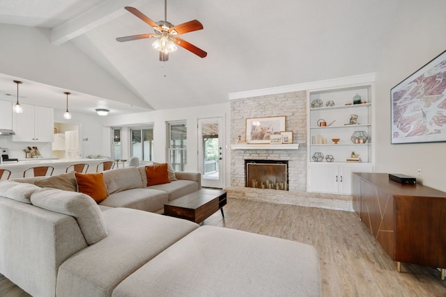 402 San Gabriel Blvd, Georgetown, TX 78628 - living room featuring light wood-type flooring, ceiling fan, beamed ceiling, a large fireplace, and high vaulted ceiling