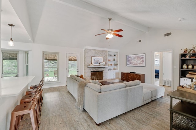 402 San Gabriel Blvd, Georgetown, TX 78628 - living room with light wood-style flooring, ceiling fan, a stone fireplace, built in features, and baseboards