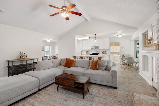 402 San Gabriel Blvd, Georgetown, TX 78628 - living room featuring light wood-type flooring, beam ceiling, ceiling fan, healthy amount of natural light, and high vaulted ceiling
