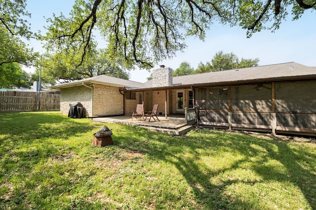 402 San Gabriel Blvd, Georgetown, TX 78628 - rear view of property with a chimney, brick siding, and a sunroom