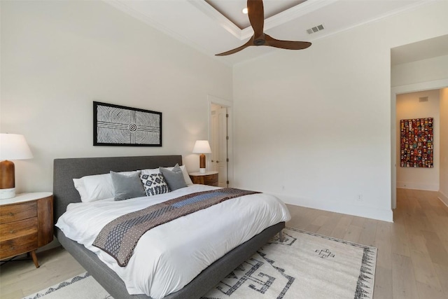 bedroom with wood finished floors, visible vents, ceiling fan, and baseboards