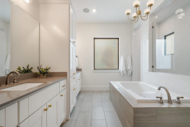full bath with recessed lighting, a chandelier, a bath, vanity, and baseboards