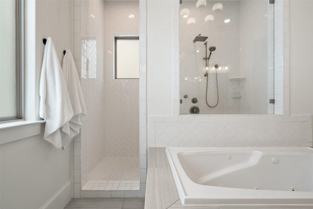 full bath with a walk in shower and a whirlpool tub