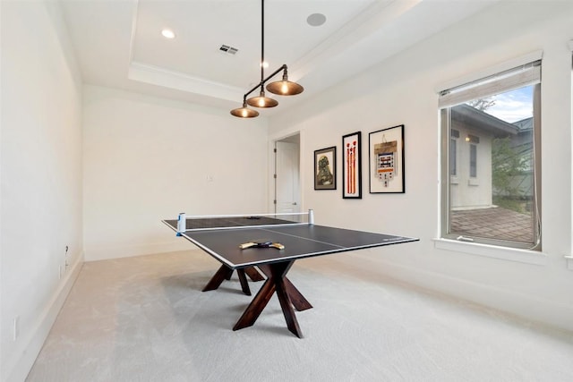 rec room with visible vents, baseboards, light colored carpet, and a tray ceiling