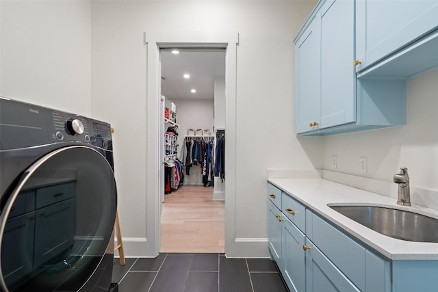 710 Crestone Stream Dr, Austin, TX 78738 - washroom with cabinet space, washer / clothes dryer, dark tile patterned flooring, and recessed lighting