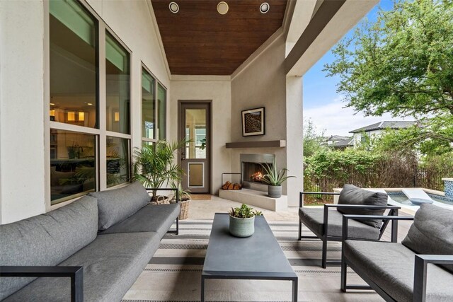 view of patio featuring an outdoor living space with a fireplace