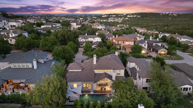 aerial view at dusk featuring a residential view