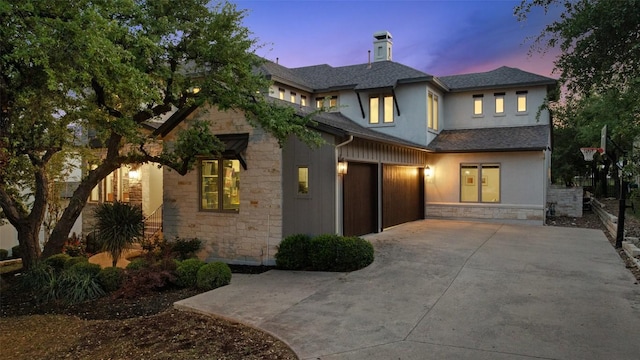 710 Crestone Stream Dr, Austin, TX 78738 - view of front facade with stone siding, concrete driveway, stucco siding, a chimney, and a garage
