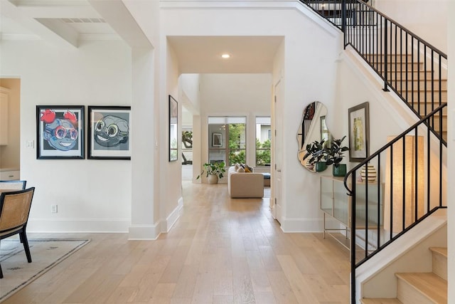 710 Crestone Stream Dr, Austin, TX 78738 - foyer entrance with light wood-type flooring, stairs, recessed lighting, beamed ceiling, and crown molding