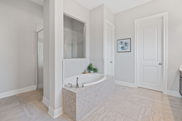 200 S Sage Holw, Dripping Springs, TX 78620 - bathroom with baseboards, a garden tub, vanity, and a shower stall