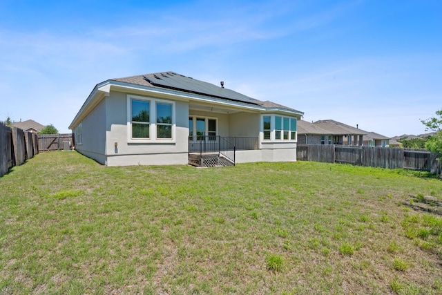 200 S Sage Holw, Dripping Springs, TX 78620 - back of property featuring a yard, roof mounted solar panels, and a fenced backyard