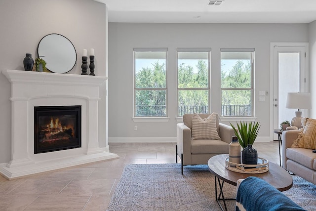 200 S Sage Holw, Dripping Springs, TX 78620 - living room with a wealth of natural light, a glass covered fireplace, visible vents, and baseboards