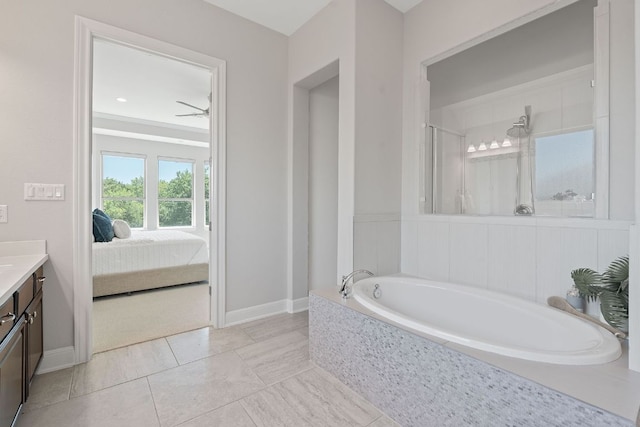 200 S Sage Holw, Dripping Springs, TX 78620 - full bathroom with vanity, a bath, ensuite bath, baseboards, and a stall shower