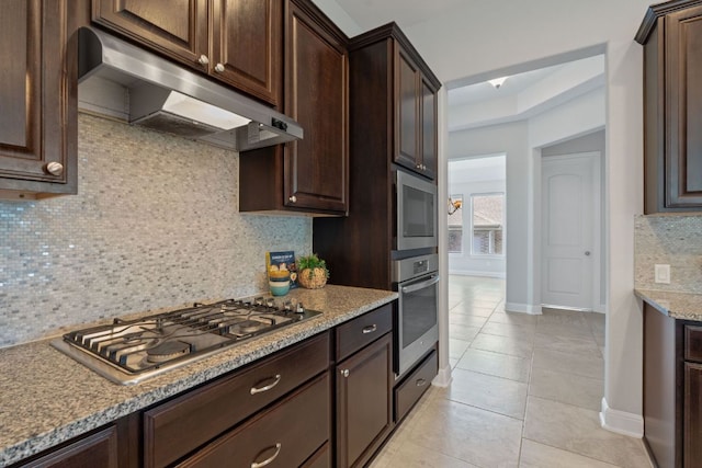 200 S Sage Holw, Dripping Springs, TX 78620 - kitchen featuring appliances with stainless steel finishes, under cabinet range hood, dark brown cabinets, and backsplash