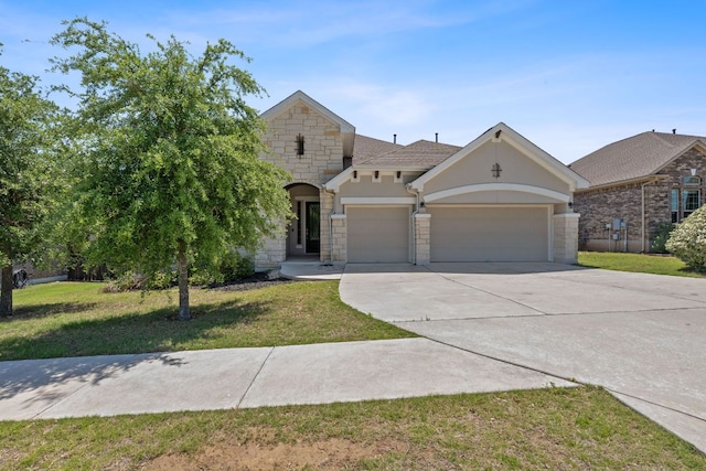 200 S Sage Holw, Dripping Springs, TX 78620 - view of front facade with a front lawn, driveway, stone siding, a garage, and stucco siding