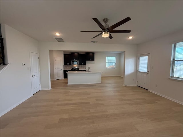 577 Backstays Loop, Kyle, TX 78640 - unfurnished living room with ceiling fan, light wood finished floors, and recessed lighting