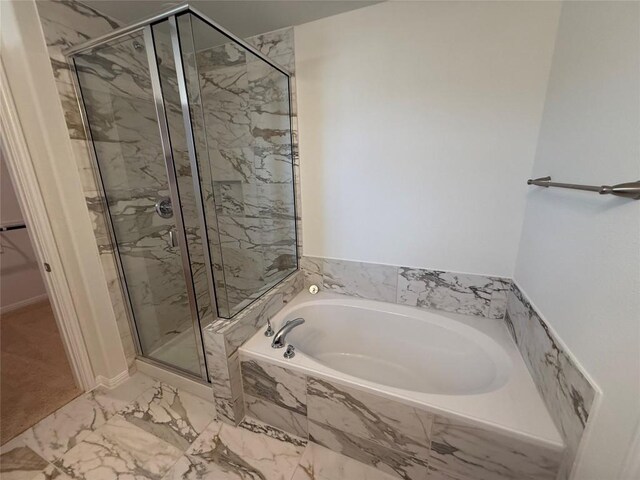 577 Backstays Loop, Kyle, TX 78640 - bathroom with a garden tub, a marble finish shower, and marble look tiles