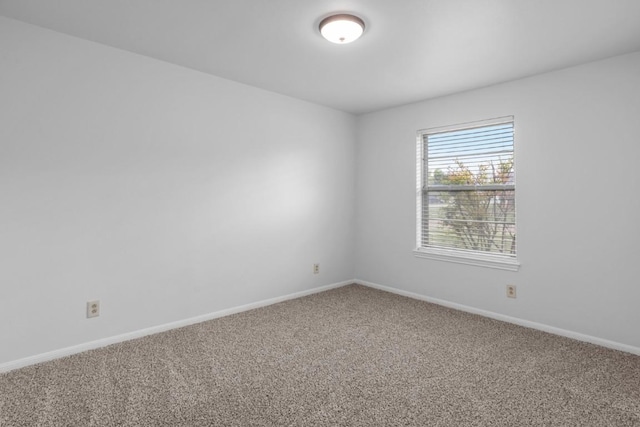 empty room with baseboards and carpet floors