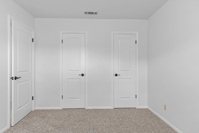 unfurnished bedroom with baseboards, visible vents, and carpet flooring