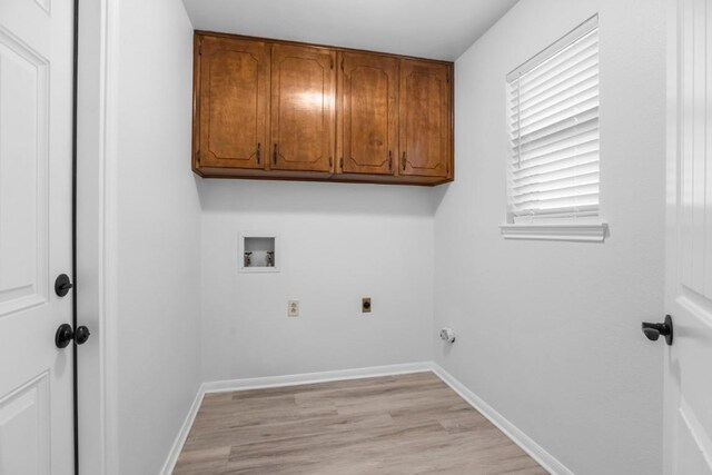 laundry area with hookup for a washing machine, hookup for an electric dryer, cabinet space, light wood finished floors, and baseboards