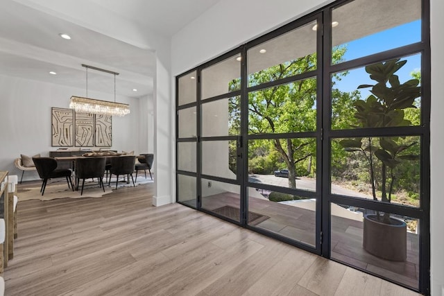 6103 Twin Ledge Dr, Austin, TX 78731 - entryway with wood finished floors, a chandelier, and recessed lighting