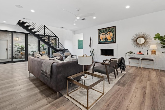 6103 Twin Ledge Dr, Austin, TX 78731 - living area with a ceiling fan, light wood-type flooring, recessed lighting, stairway, and a fireplace