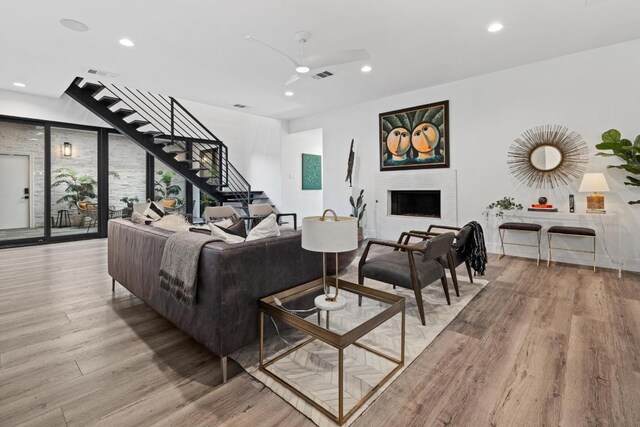 6103 Twin Ledge Dr, Austin, TX 78731 - living area with a ceiling fan, light wood finished floors, stairs, recessed lighting, and a fireplace