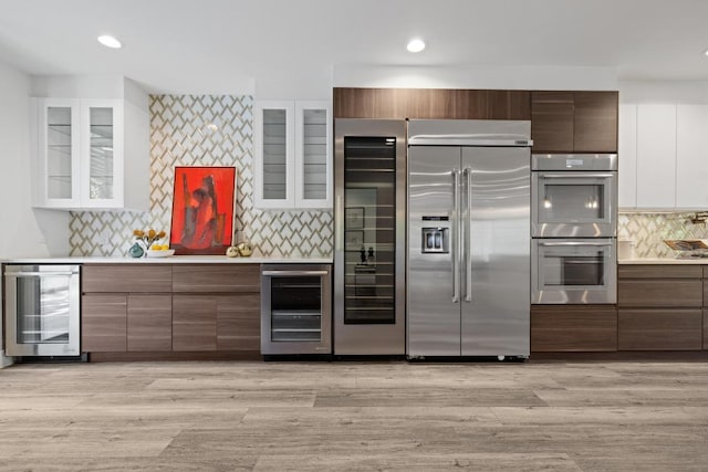 6103 Twin Ledge Dr, Austin, TX 78731 - kitchen with appliances with stainless steel finishes, wine cooler, light countertops, and recessed lighting