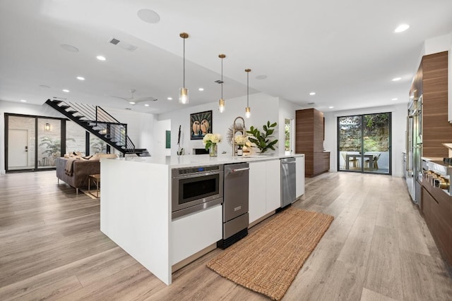 6103 Twin Ledge Dr, Austin, TX 78731 - kitchen with modern cabinets, white cabinets, light wood-type flooring, recessed lighting, and dishwasher